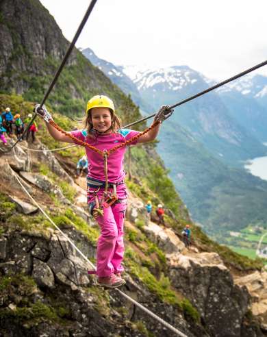 Young girl crossing the Via Ferrata in Loen in Fjord Norway