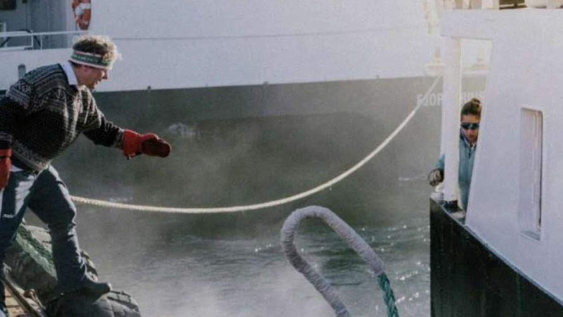 The Captain, Mads, reels in the boat.
