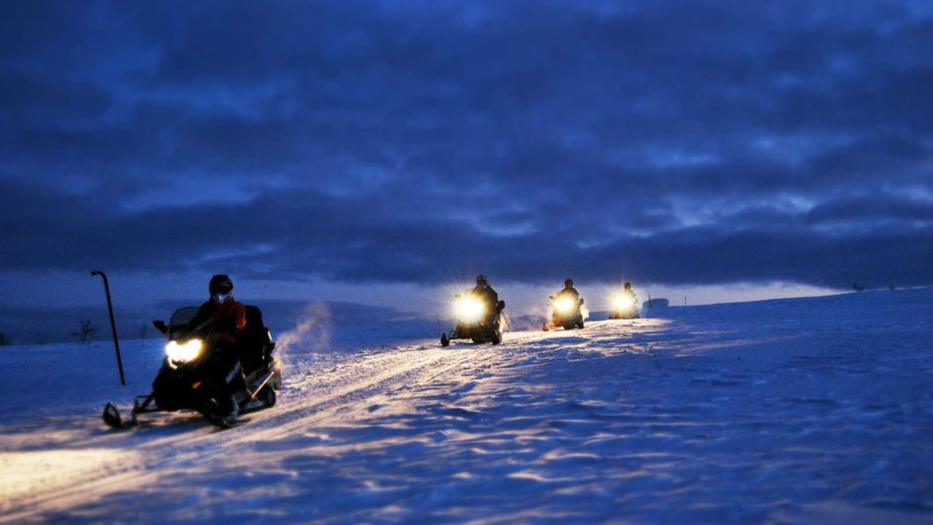 Northern lights hunt with snowmobile