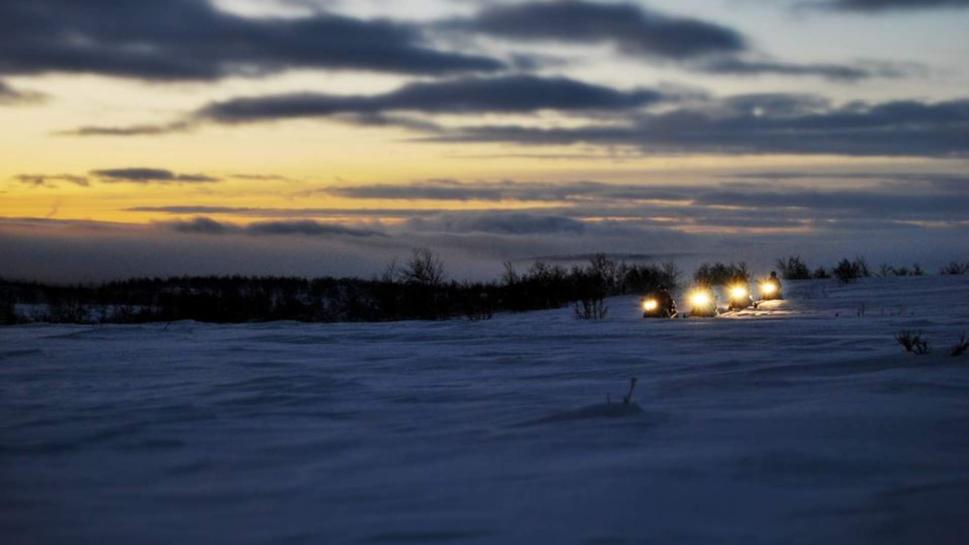 Northern lights hunt with snowmobile