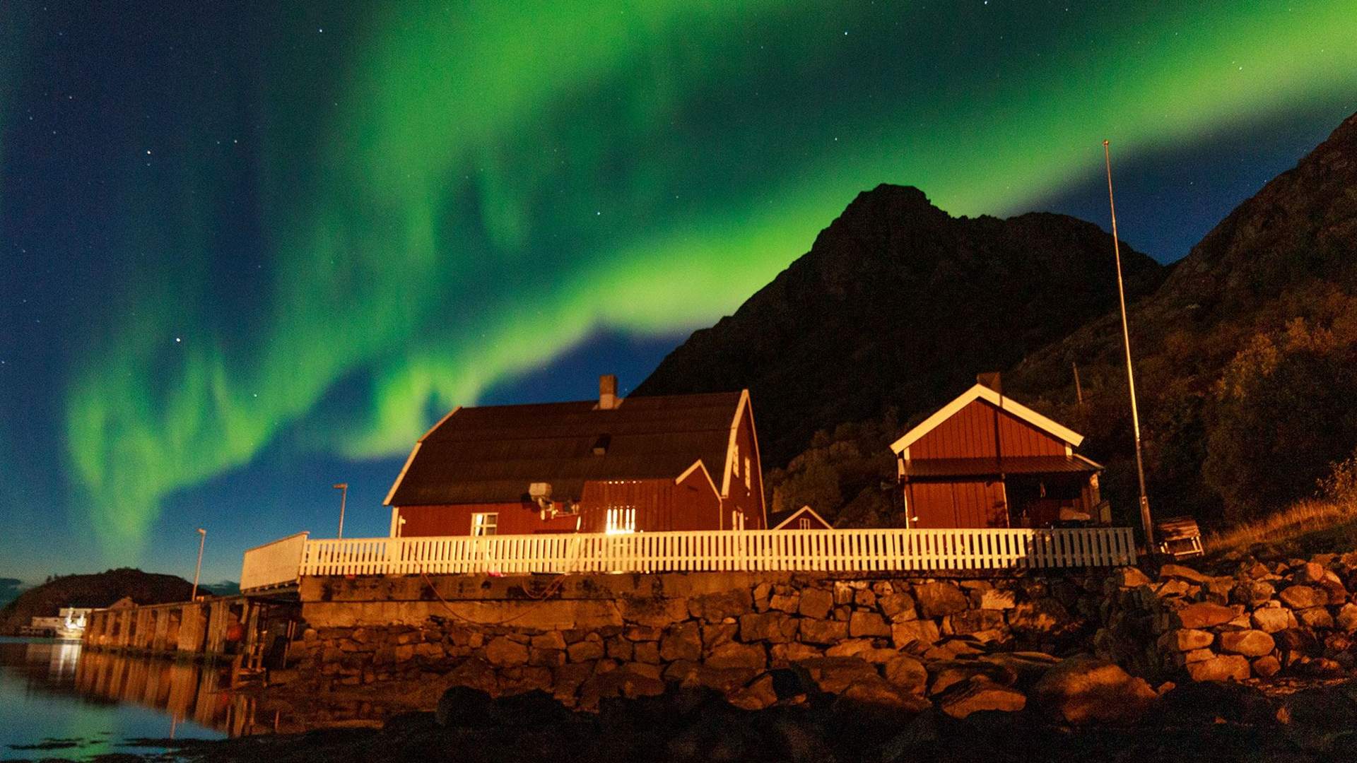 Northern light above Vesterålen fisherman's cabins