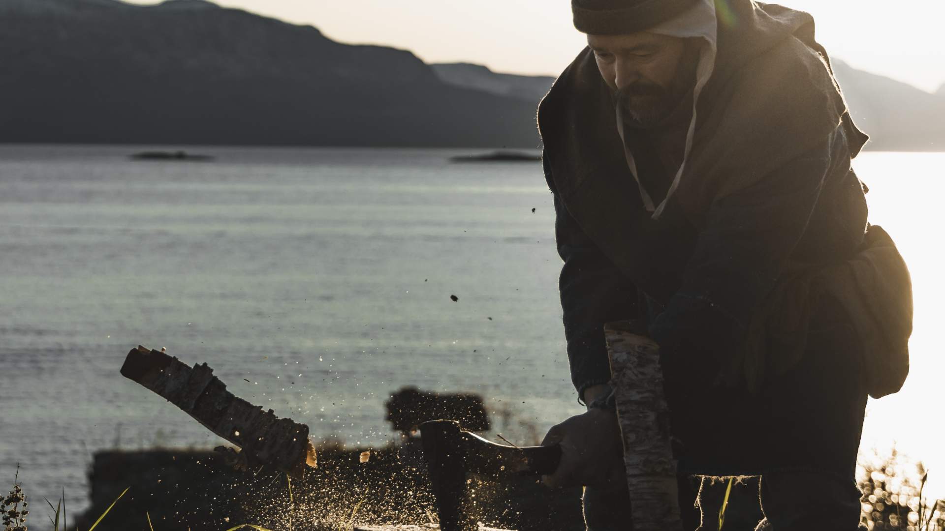 Arcticoncepts-Harstad-medieval farm-viking-axe-chopping wood-foto André Askeland