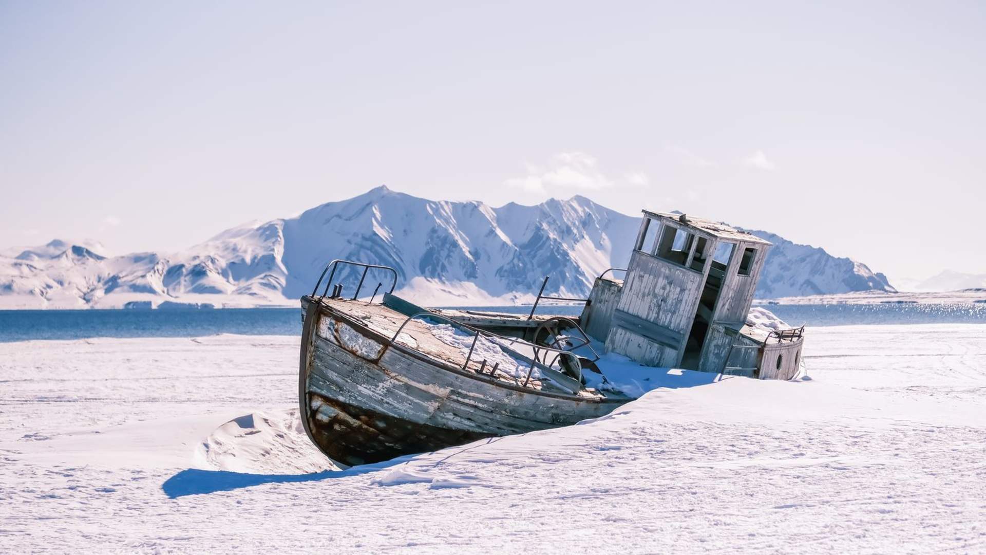 abandones-weathered-boat-partially-buried-in-snow