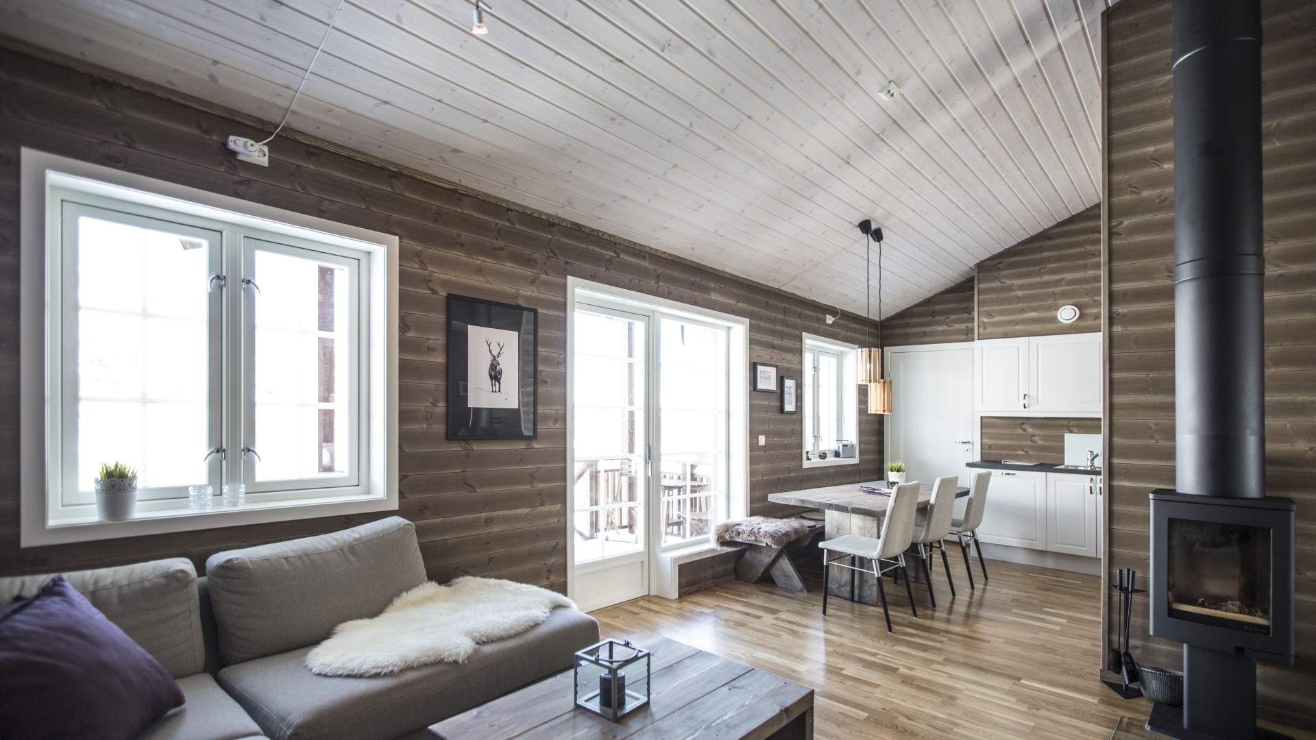 Stue og kjøkken i en av leilighetene, med dør ut til veranda