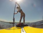 SUP Sackets Harbor co-owner Jamie McGiver, on a paddleboard, is a World Paddle Association Stand Up Paddleboard on-board yoga instructor. Photo: SUP Sackets Harbor