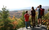 A family enjoys the view from atop Coon Mountain in Westport on Lake Champlain.