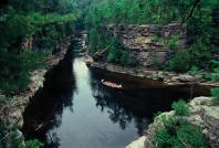 As they paddle down the Ausable River, travelers gaze up at the towering cliffs. (Ausable Chasm, NY). © NYS Dept.of Economic Development (photo by Darren McGee)