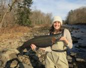 New York City attorney Emily Viglietta holds a beautiful steelhead taken last fall on the upper Salmon River in Oswego County.