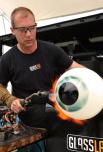 GlassLab gaffer Erik Meek works on a glass eye by designer Sigga Heimis