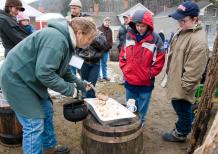 Visitors to Sugaring Off Sundays at The Farmers’ Museum in Cooperstown enjoy the sweet taste of jack wax, an old tradition in maple syrup country. (Photo by Zach Winnie)