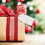 Christmas package with red ribbon bow and blank tag