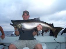 Tim Spraker holds a shiny king salmon landed near Oswego while fishing with Captain Ed Monette, Cannonball Runner Charters. (Photo by Capt. Ed Monette.)