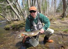 Fran Verdoliva, Salmon River Program Coordinator for the DEC, holds a nice spring steelhead. The fish was released back into the river. (Photo by Jessica Burt, Oswego County Tourism Office.)