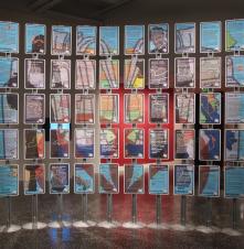 Carrying (Pistol Packing Pupils), by Belshe/Prown (Curt Belshe and Lise Prown), an installation of 50 digital prints on aluminum, and steel.