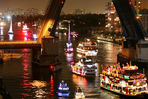 Fort Lauderdale's 50-year-old Winterfest Boat Parade features a lights, decorations, music, performers, and illuminated watercraft on the New River.