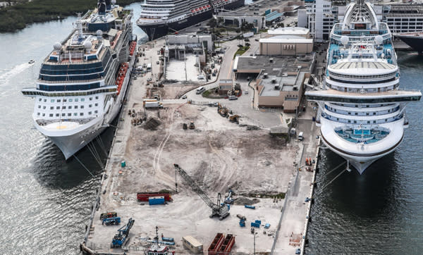 Aerial photo looking south of the Cruise Terminal 25 construction area showing several building walls have been torn down and land has been leveled for new construction.