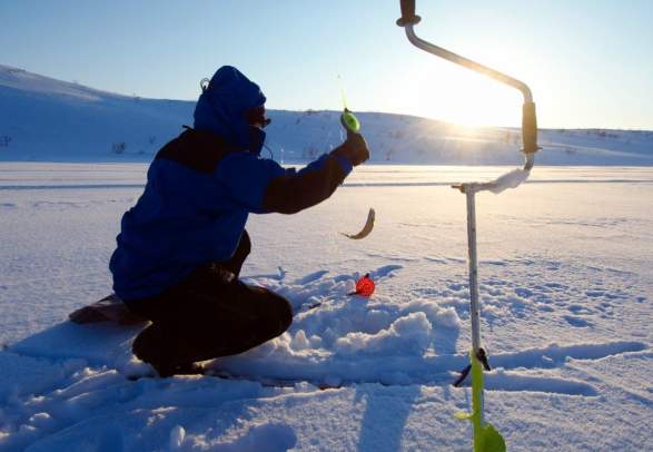 Ice fishing on the fjord in Lyngen - XLyngen