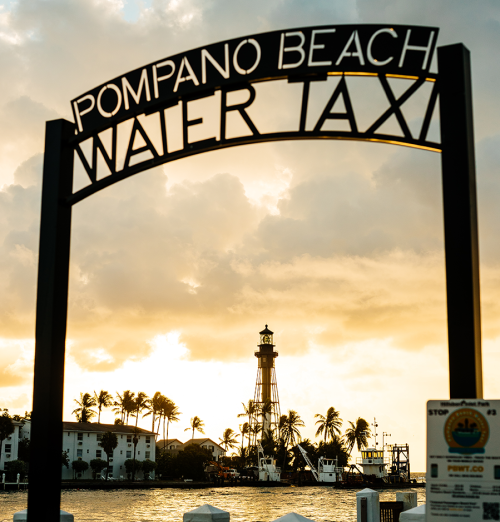 Sign in front of the water for the Pompano Beach water taxi