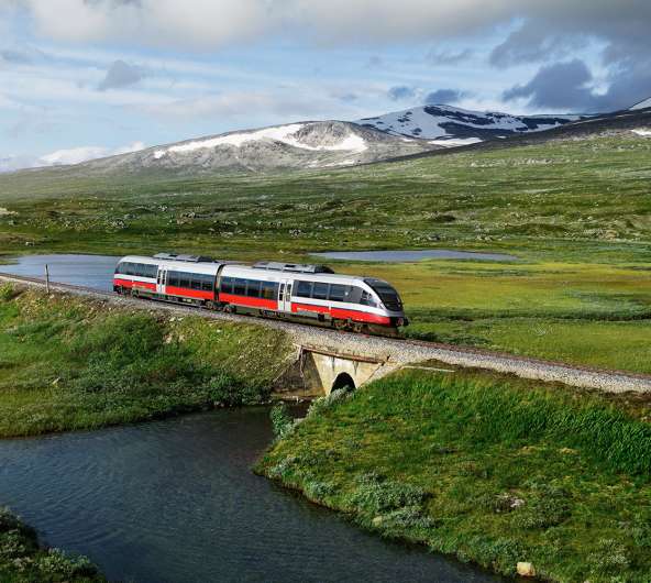 A train passing by a lake in Saltfjellet mountain area in Nordland