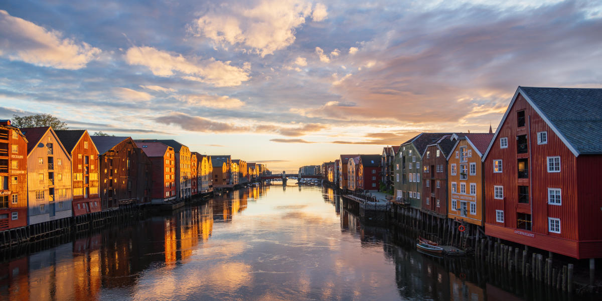 Sunset over the old wooden houses along the Nidelven river in Trondheim in Trøndelag, Norway
