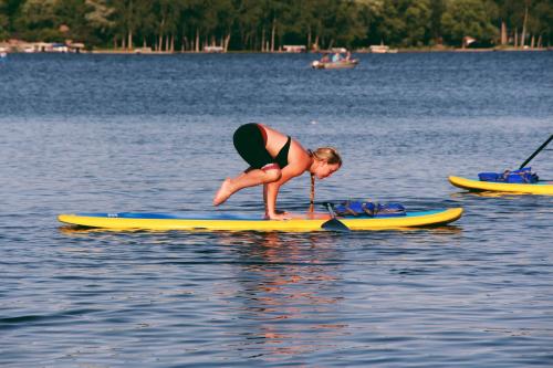 Woman completing Funky Buddha's paddleboard yoga