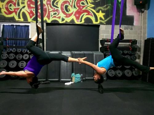 women attending a G-Force Fitness aerial yoga class