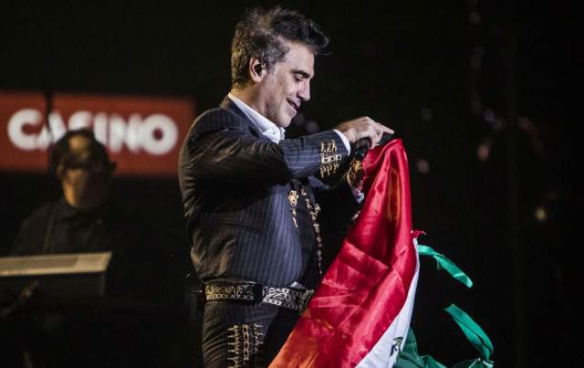 Alejandro Fernandez holding Mexican flag