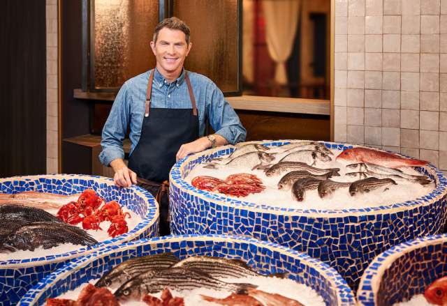 World famous chef Bobby Flay standing proudly in front of his fresh seafood at Amalfi in Las Vegas.