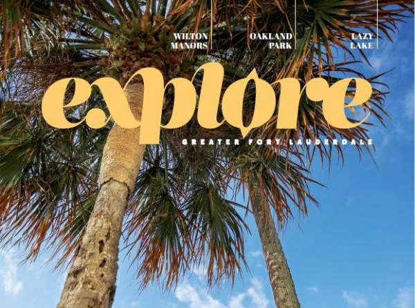 Cover of Explore GFL magazine showing an apartment building in Wilton Manors framed between two palm trees