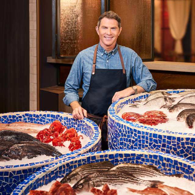 World famous chef Bobby Flay standing proudly in front of his fresh seafood at Amalfi in Las Vegas.