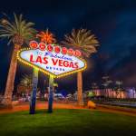 The iconic Welcome to Fabulous Las Vegas sign glowing against the night sky.