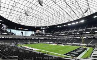 Interior view of allegiant stadium showing the Raiders football field surrounded by stadium seating.