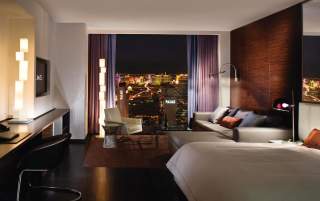 Single bed hotel room with couch and views of the Las Vegas Strip