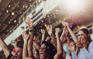 A group of excited sports fans cheering on their team!