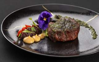 Dig into this perfectly seared filet mignon, plated to perfection at Scotch 80 Prime at Palms Casino Resort in Las Vegas.