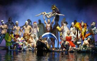 A group of performers posing on stage during the O show by Cirque du Soleil.