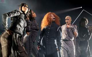 Janet Jackson and performers on stage.