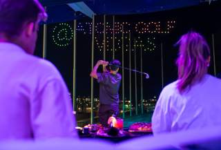 A player enjoying a game at Atomic Golf at the STRAT Hotel, Casino & Tower.