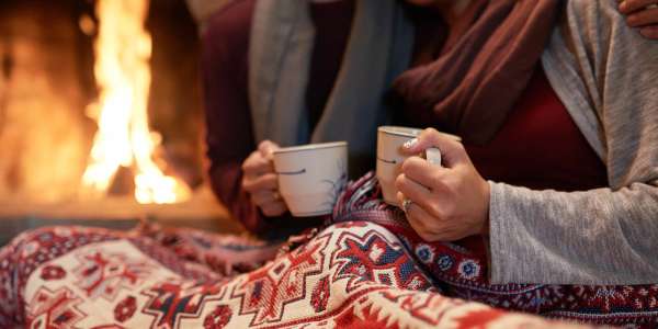 Winter – in front of a cozy fire with a cup of cocoa