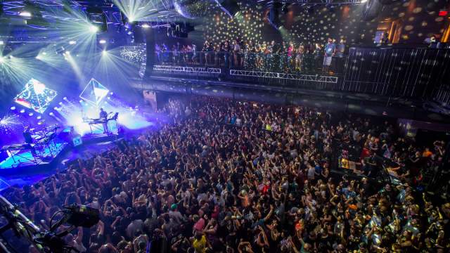 A fun and lively concert being performed at Brooklyn Bowl in front of a roaring crowd.