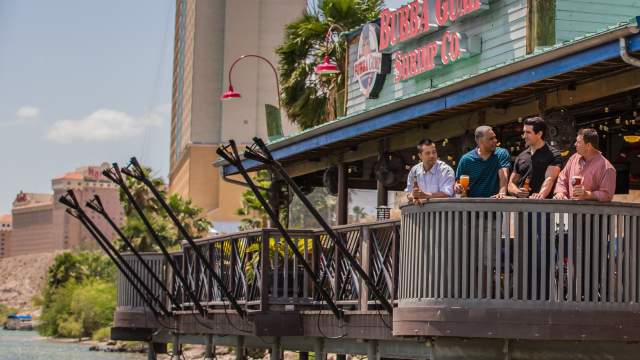 Men having beers on balcony at Bubba Gump Shrimp Co. in Laughlin