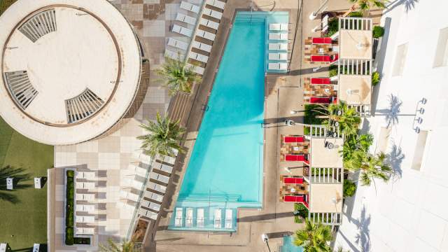 Aerial view of the pool at Don Laughlin's Riverside Casino & Resort with lounge chairs and cabanas.
