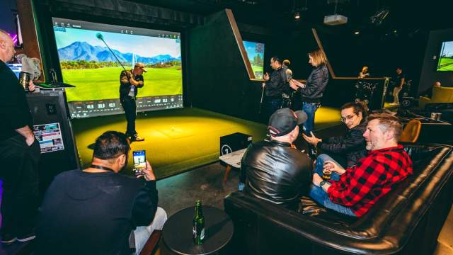 People using golf simulator at Five Iron Golf in Area 15
