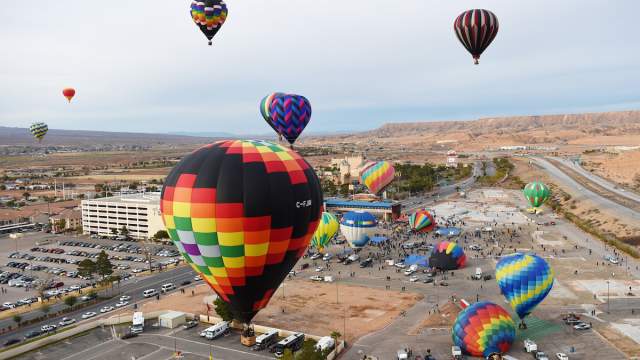 Hot air balloons rising into the air at the Hot Air Balloon Festival in Mesquite.