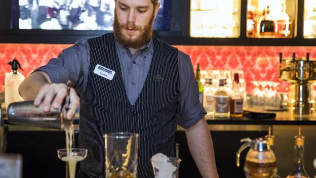 Bartender pouring drinks at The Underground Speakeasy & Distillery in The Mob Museum.