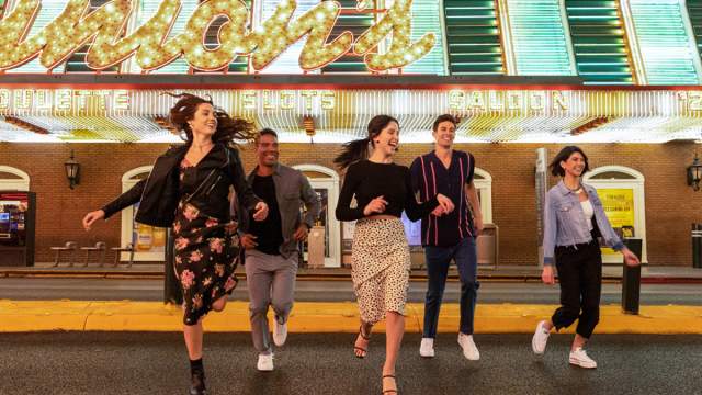 Friends walking in downtown Las Vegas for the Fremont Street experience.