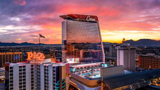 Beautiful lights of Las Vegas seen from a distance focusing in on Circa and stadium swim.