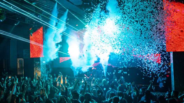 The crowd dances all night long to the music that a DJ plays at Tao Nightclub.