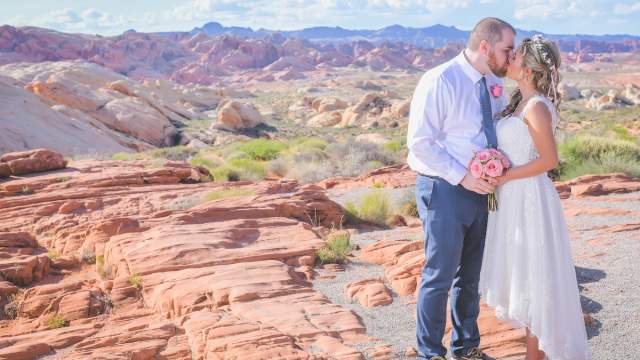 A couple sharing their first kiss as a married couple at Red Rocks outside of Vegas.