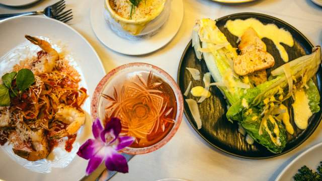 A close up of delicious dishes and cocktail at Gregory's Mesquite Grill.
